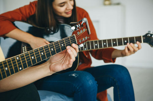 Adult student playing guitar