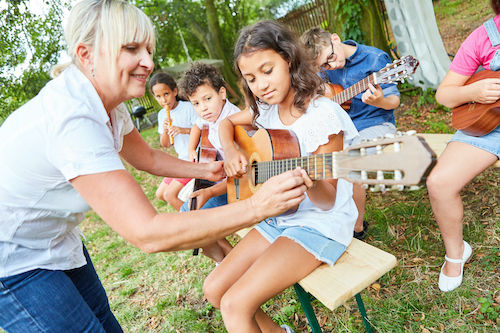 Young student playing guitar